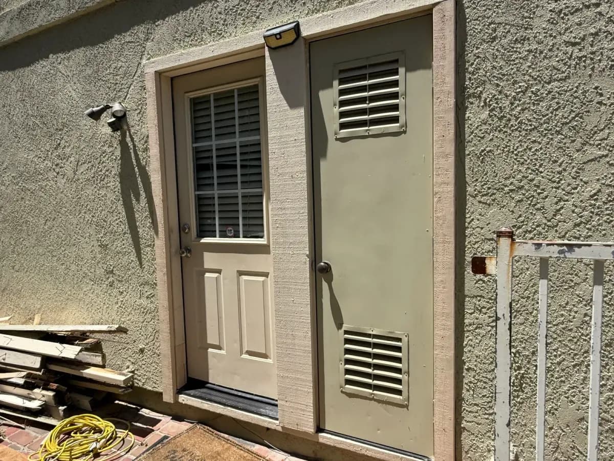 Exterior entry and utility doors with new trim around both openings