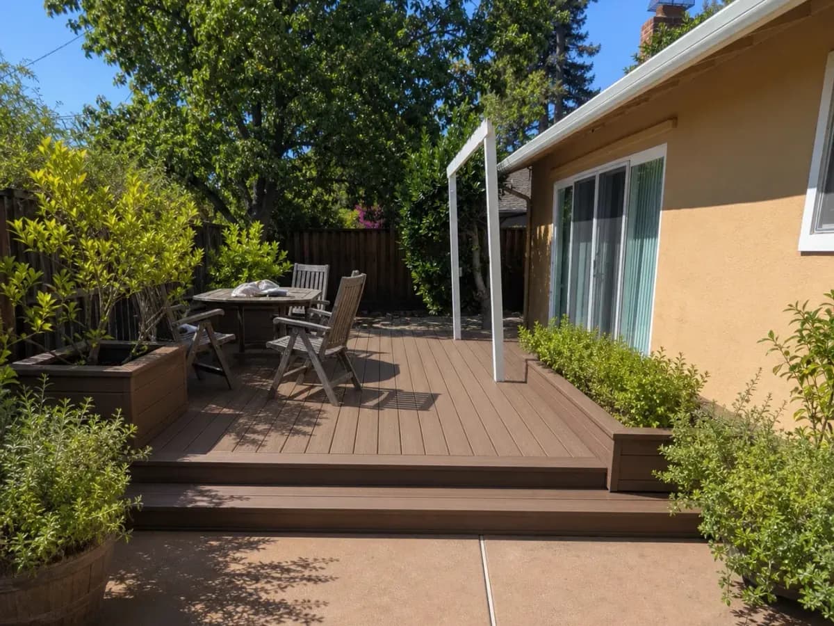 Composite backyard deck with steps beside a house