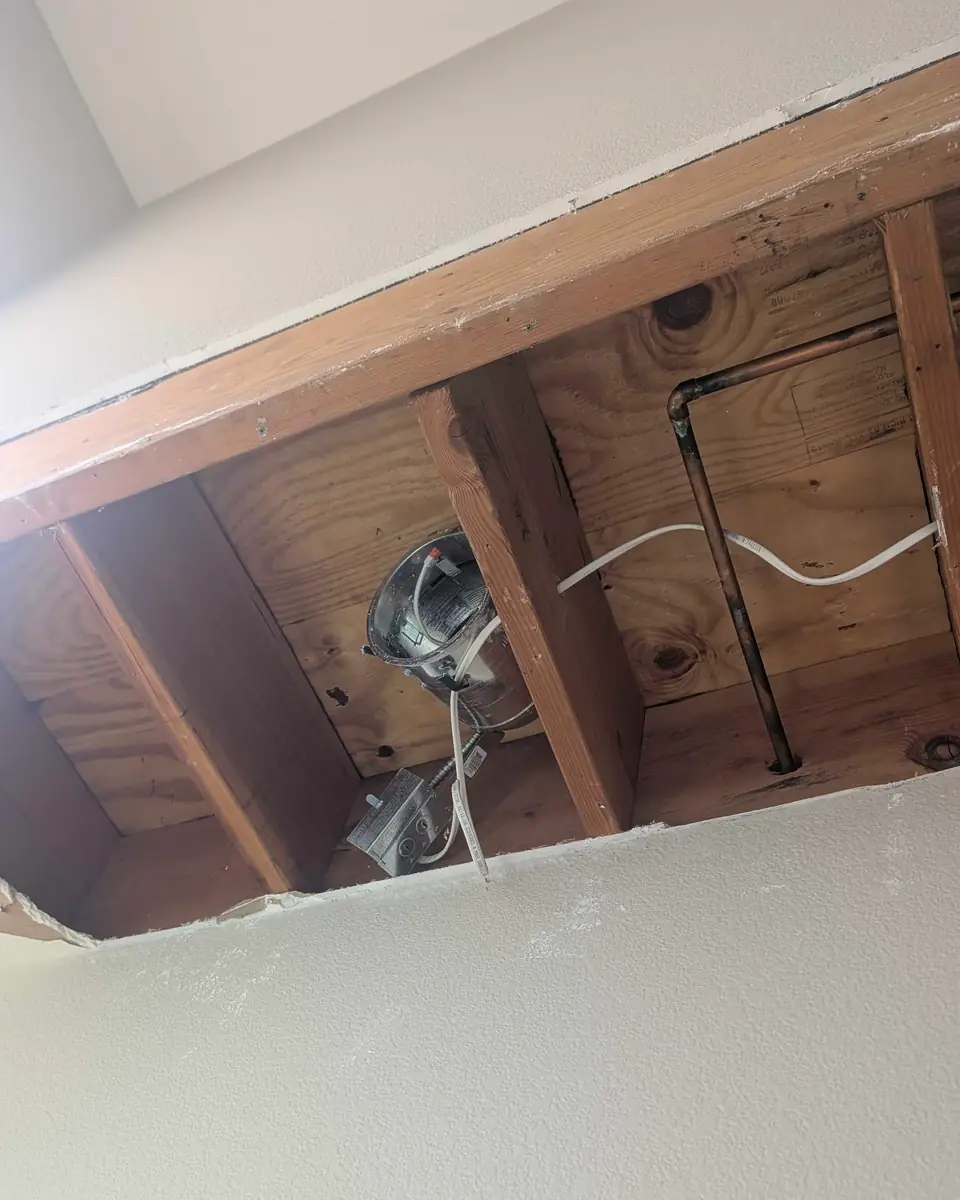Ceiling opened around framing during interior drywall restoration
