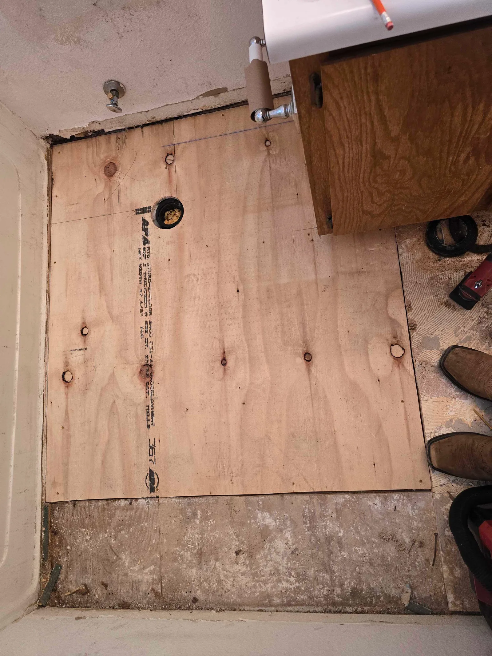 New plywood subfloor fitted around the toilet opening