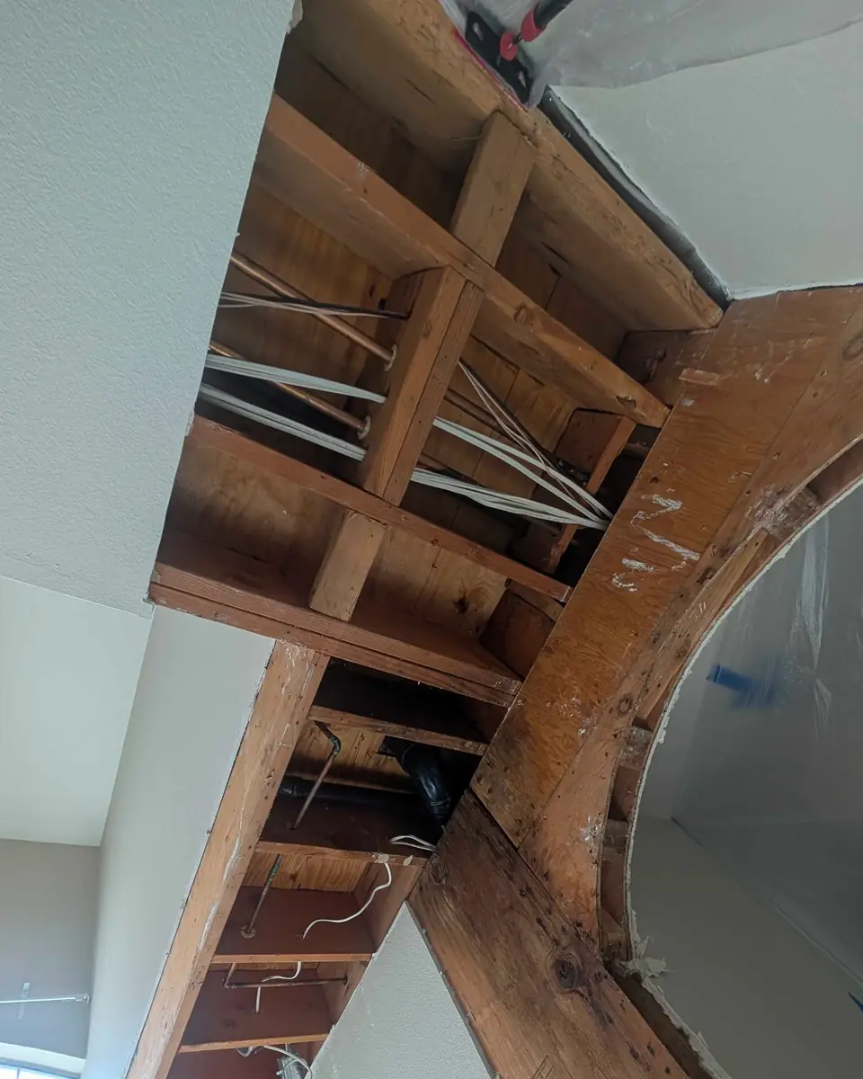 Ceiling framing exposed above an interior room during restoration