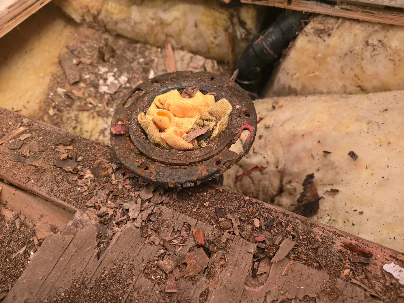 Deteriorated subfloor around the toilet flange